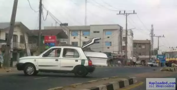 Small car carrying big coffin draws attention in Ibadan (photo)